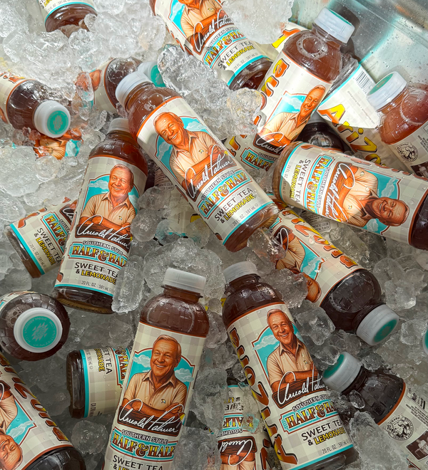 Bottles of Arizona Arnold Palmer with Sweet Tea and lemonade on ice with visible branding.
