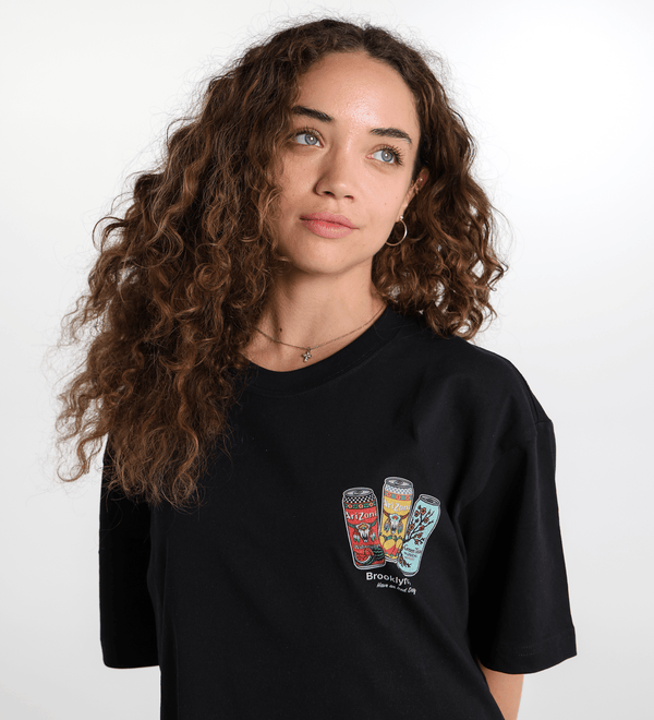 Person wearing a black t-shirt with graphic designs on a white background