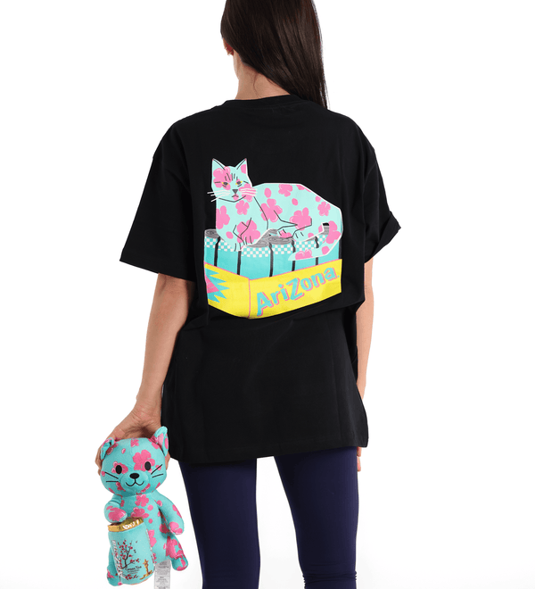 Person wearing a black t-shirt with a colorful cat design and 'Arizona' text, holding a matching plush toy.