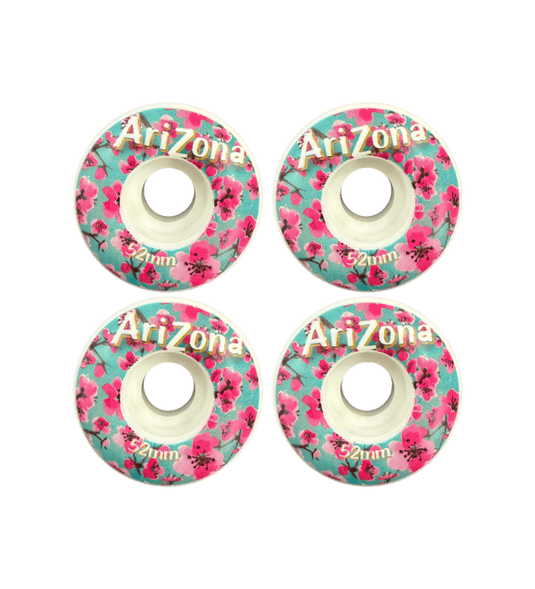 Four Arizona branded skateboard wheels with floral design on a black background