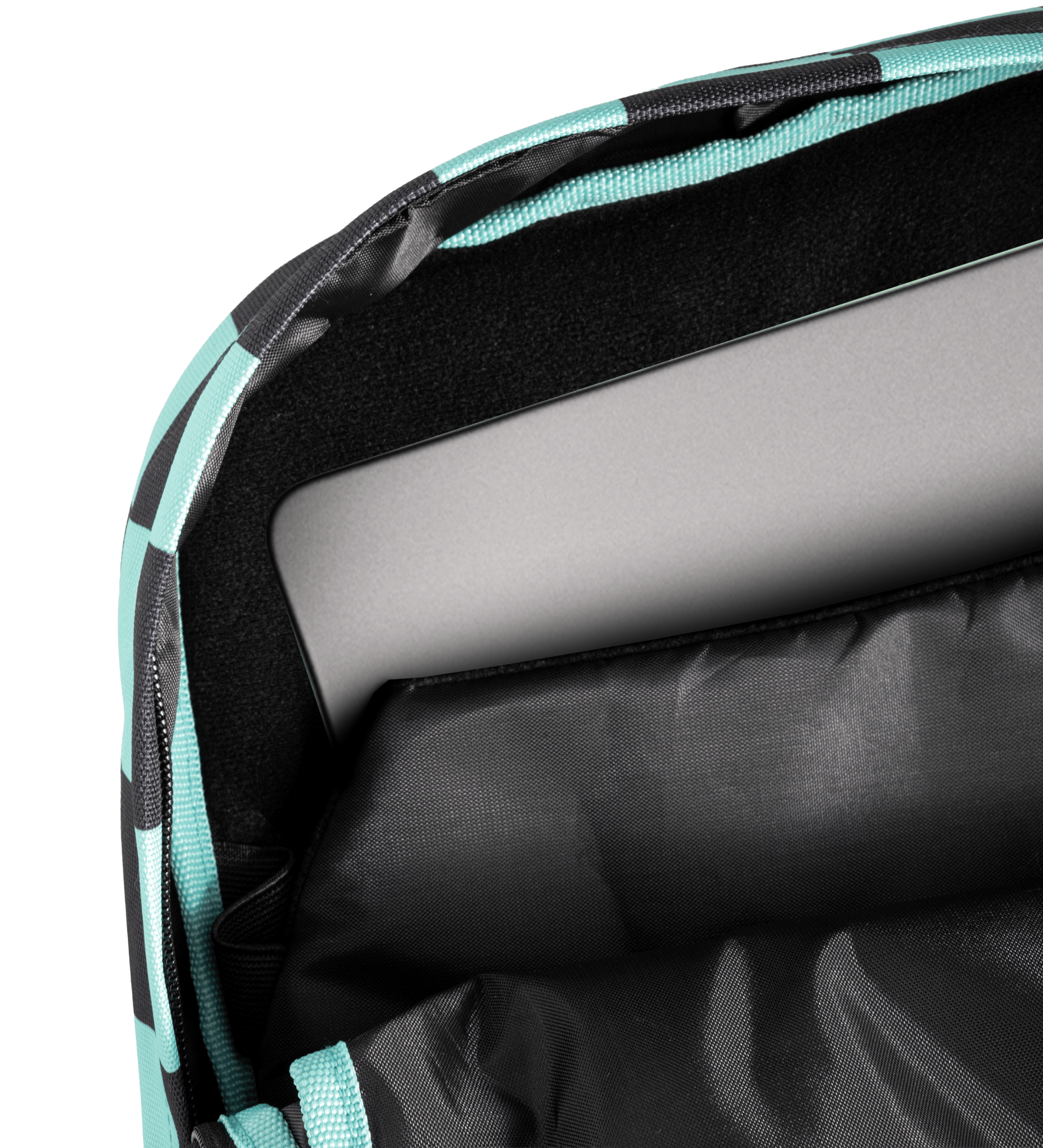 Close-up of a laptop compartment inside a backpack, showing a gray laptop resting on black padded lining with a black and mint green patterned exterior visible along the edge.