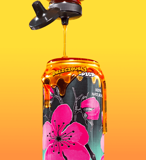 Mikes Hot Honey Az Can with honey being poured over it against a gradient yellow to orange background