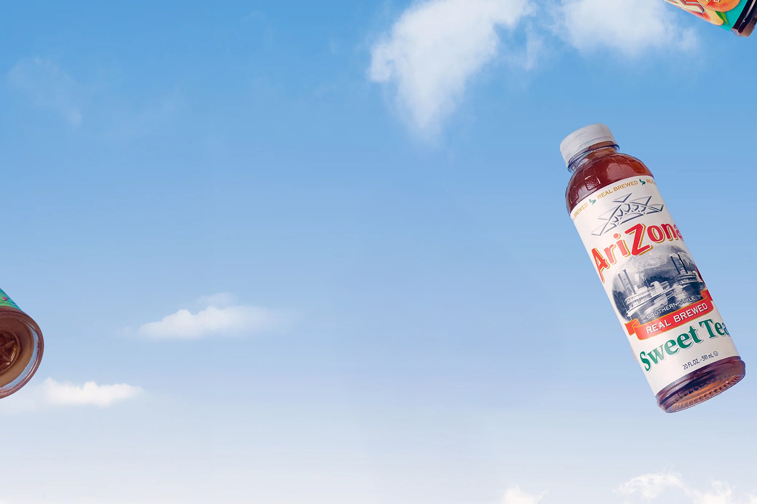 Arizona Sweet Tea bottle against a blue sky with clouds