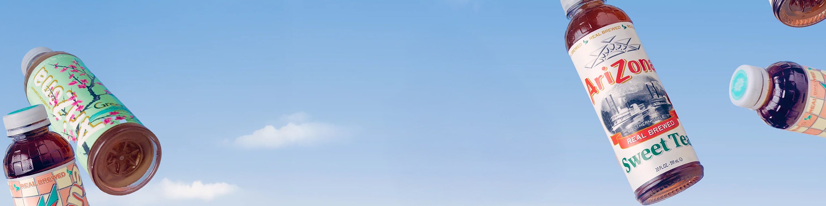 Bottles of Arizona 20oz bottles against a blue sky with white clouds