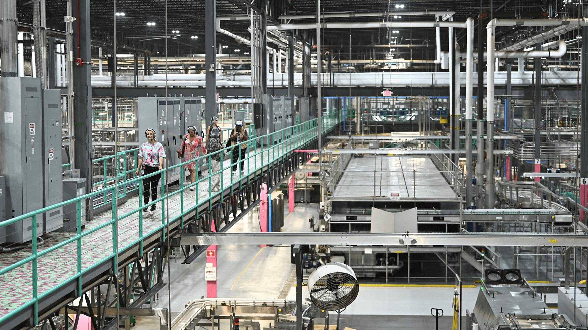 Factory interior with conveyor belts and workers at AriZonaLand
