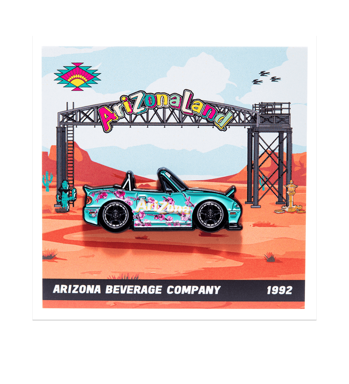 A square printed graphic or art print featuring a stylized desert scene with an Arizona Land archway and a turquoise convertible car covered in pink floral graphics. The bottom text reads 'ARIZONA BEVERAGE COMPANY 1992'.