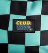 Close-up of a black and mint green checkered fabric Backpackwith a central embroidered patch reading 'CLUB ZONA' in yellow, pink, and blue.