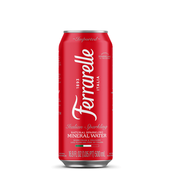 A 500 mL can of Ferrarellé Italian Sparkling Mineral Water on a solid black background. The can features the brand name 'Ferrarellé' in white script on a vibrant red background, with gold accents at the top rim and bottom base.