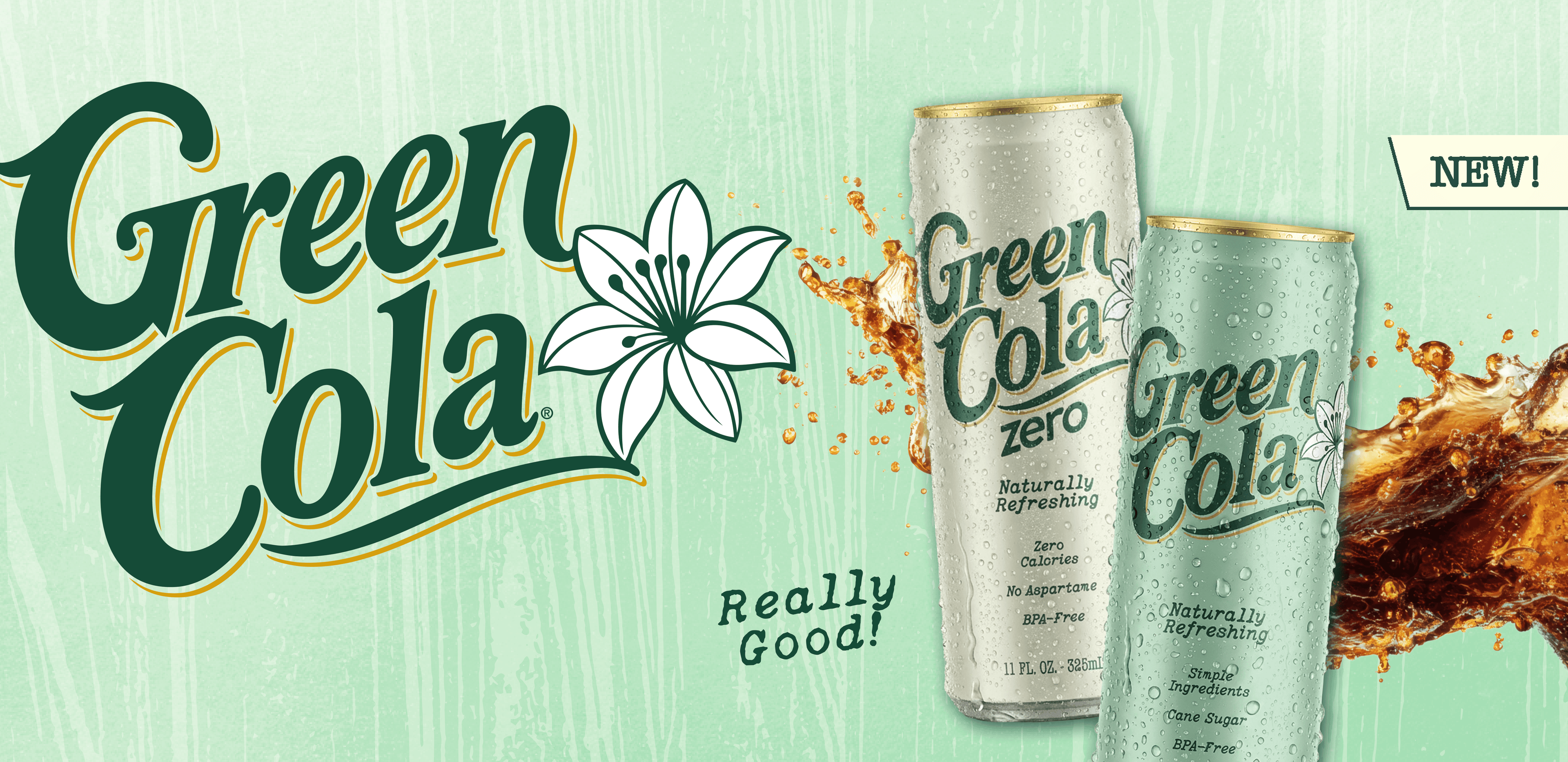 Two Green Cola Zero beverage cans on a light mint green background with the Green Cola logo, a white flower graphic, and a splash of dark cola. A small 'NEW!' label appears in the top right.