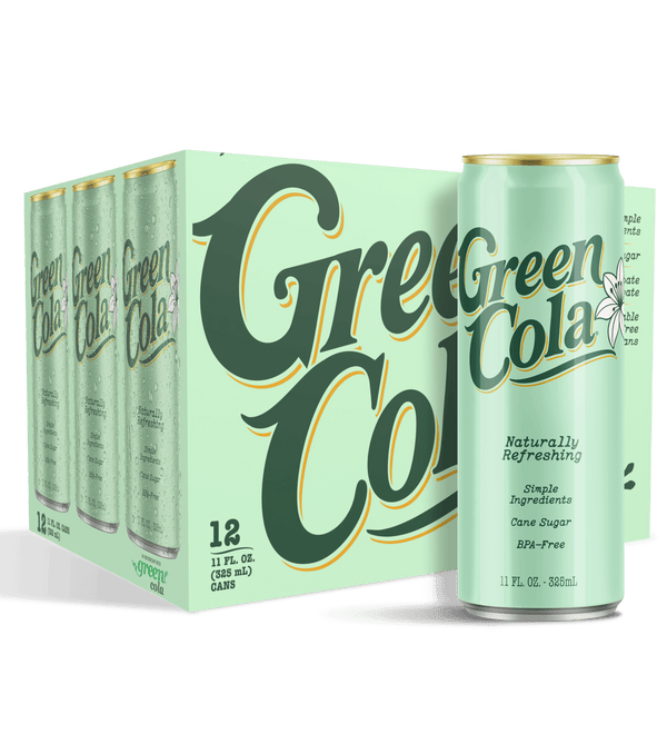 A 12-pack of Green Cola cans shown as a cardboard carton with one can standing in front, on a black background. The packaging and can are a pale mint green with large dark green script reading 'Green Cola' outlined in yellow, plus smaller white text and a small flower logo.
