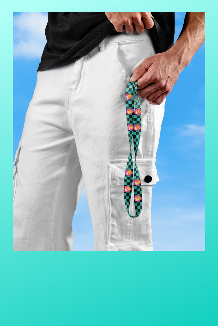Person wearing white pants with a colorful lanyard against a blue sky background